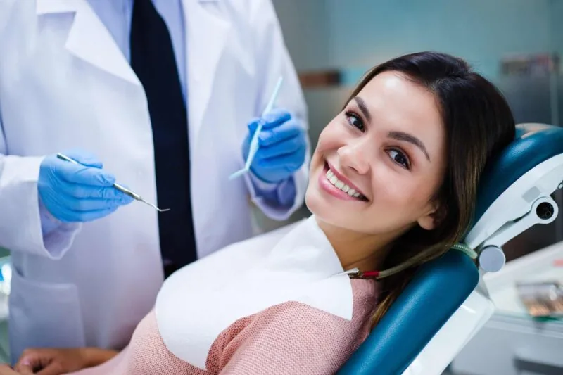 A patient smiling in the dental chair during a checkup